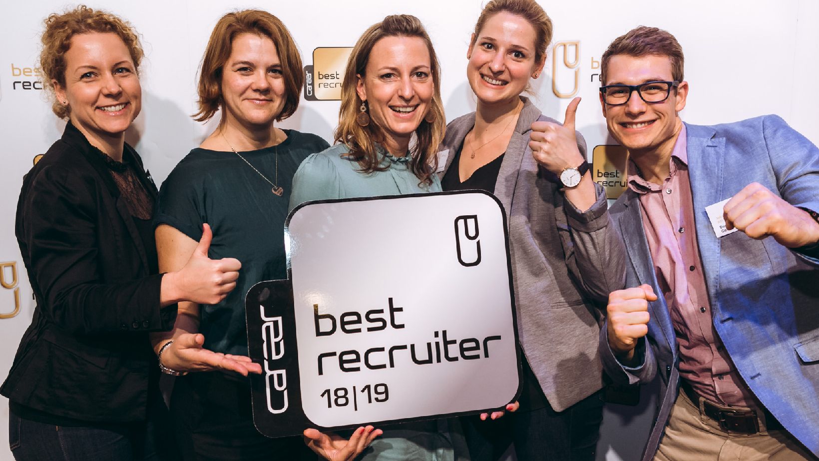 Unser HR Recruiting Team, 4 Damen, 1 Herr, halten das silberne Best Recruiters Siegel