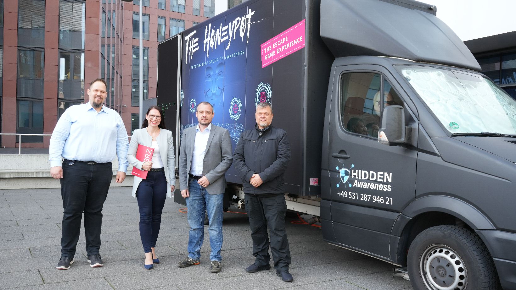 Escape Room Truck, @BRZ/Rommelt Pineda Personen stehen von dem Truck